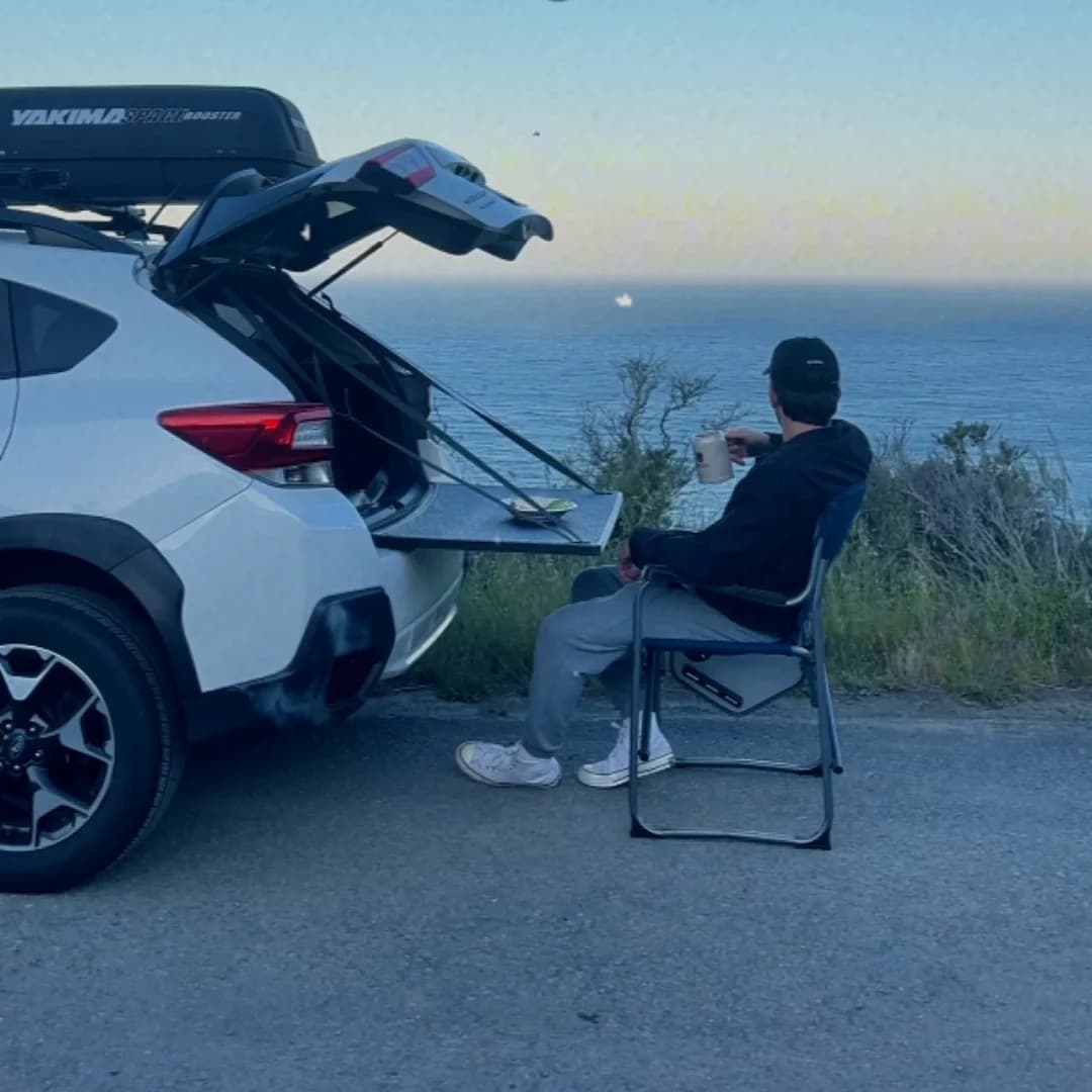 Frame from CaJu's finished Flotable campaign film: using the table beside the ocean